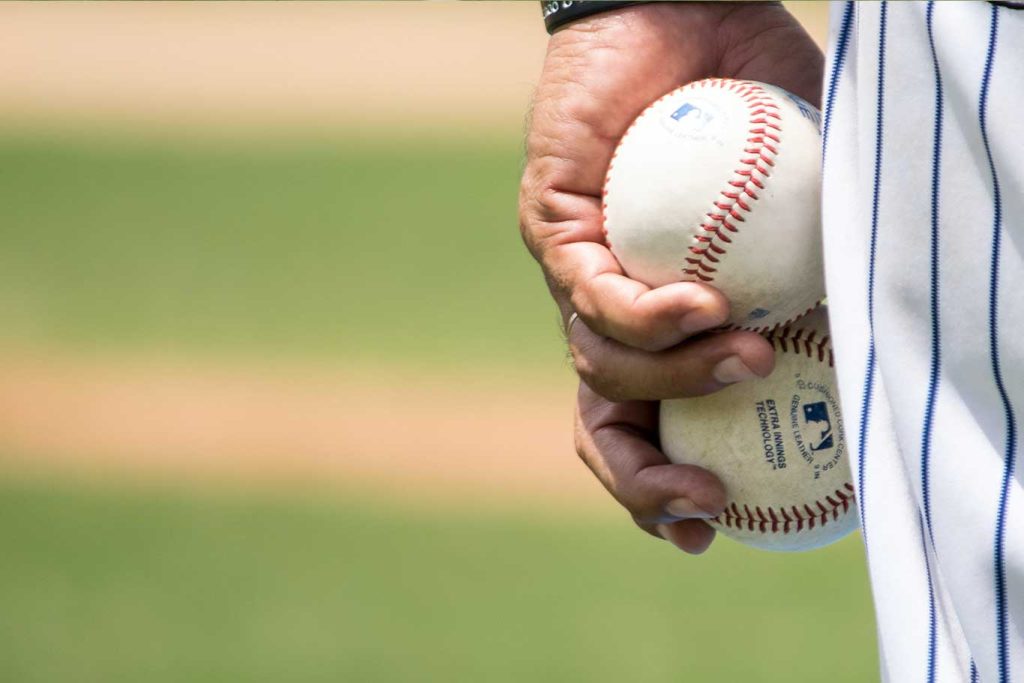 Jake Arrieta Elite Core Pilates Routine baseball pilates baseball pitcher holding two baseballs